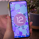 A photo of a hand holding a Pixel 5 with the Android 12 easter egg
